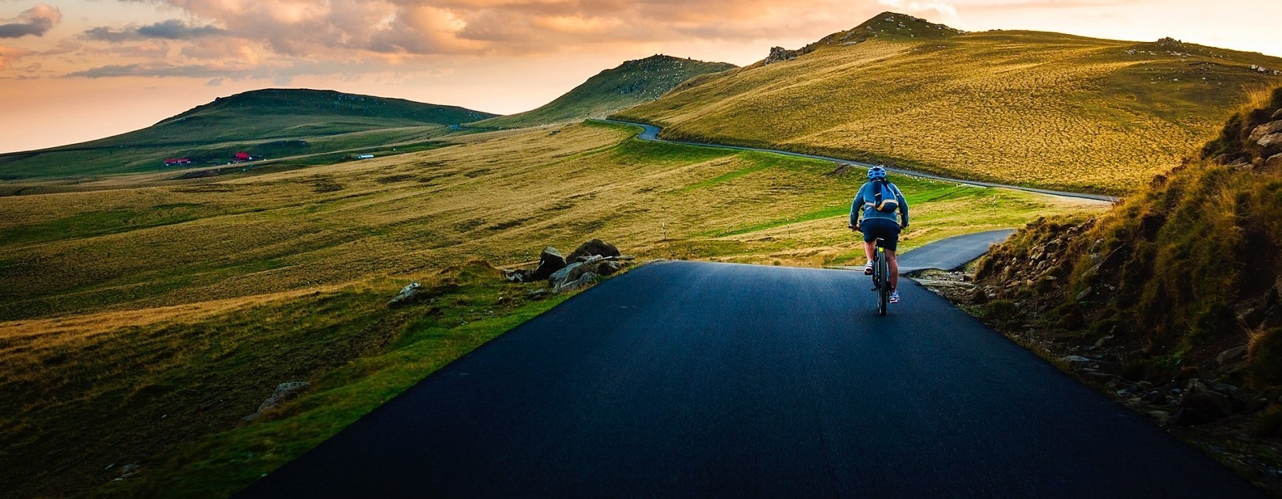 Road Cyclist with Rolling Hills in Background