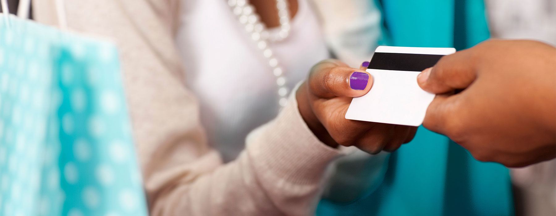 Two Hands holding a white plastic card with magnetic stripe